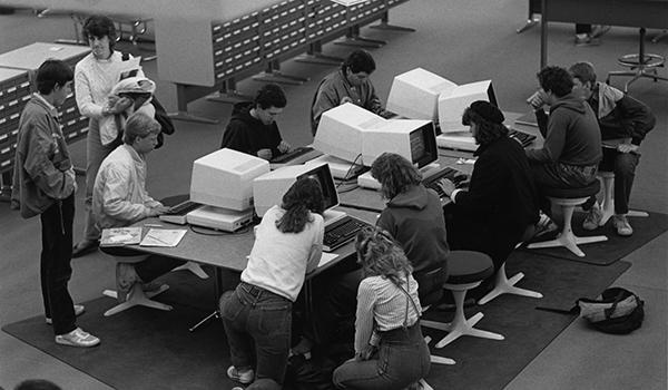 Students using the first computer catalog in the Michener Library reference area